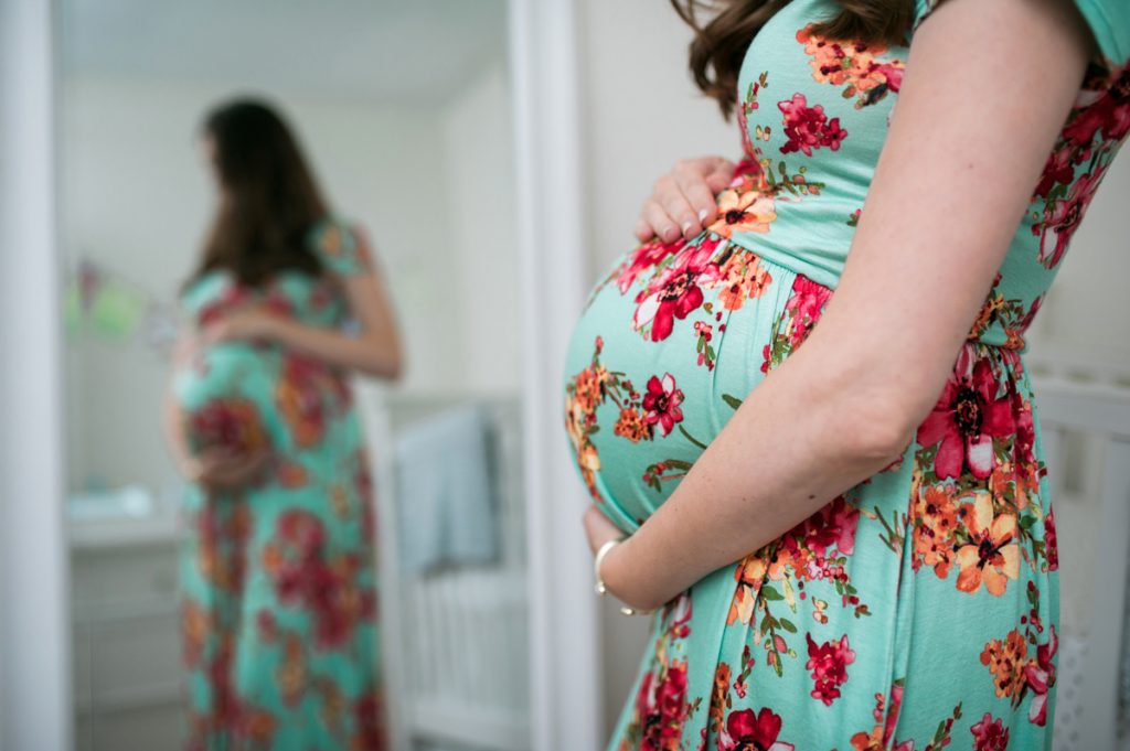 pregnant woman with gestational diabetes looking into mirror