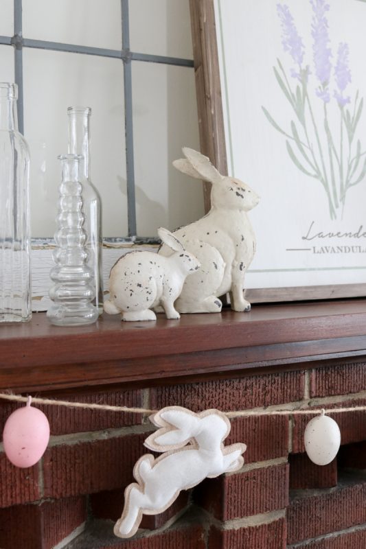 Take a peek into our home at Easter time our farmhouse-inspired mantle decor with a touch of rustic flair. I always love to extend any decor past a single holiday and removing the garland will help the mantle decor stay in season all spring long.