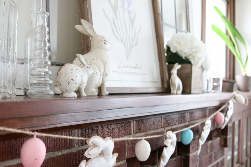 Take a peek into our home at Easter time our farmhouse-inspired mantle decor with a touch of rustic flair. I always love to extend any decor past a single holiday and removing the garland will help the mantle decor stay in season all spring long.