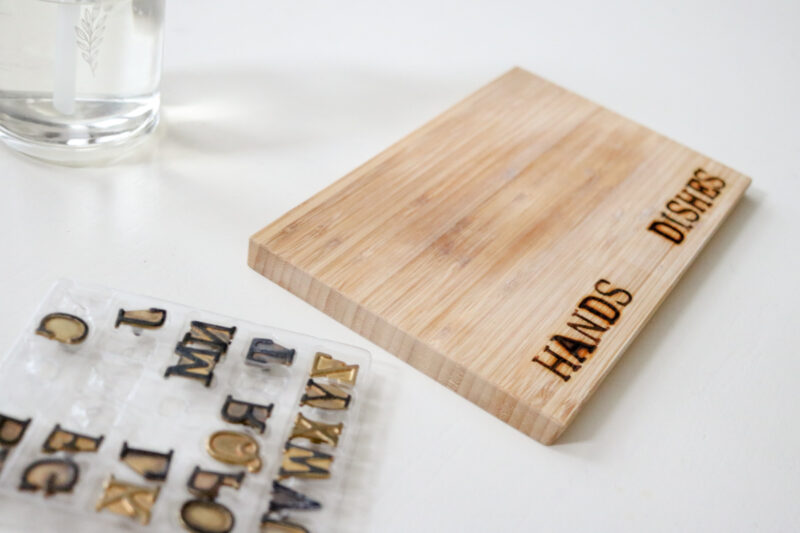 DIY woodburned kitchen soap dispenser tray with HANDS and DISHES labels